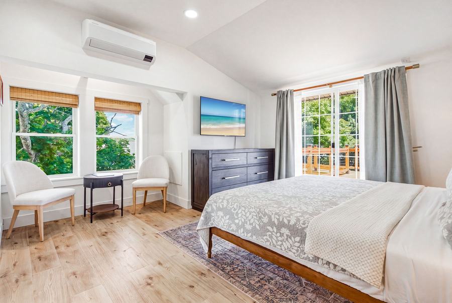 Spacious Penthouse B king suite with seating, TV, large windows, and natural light.