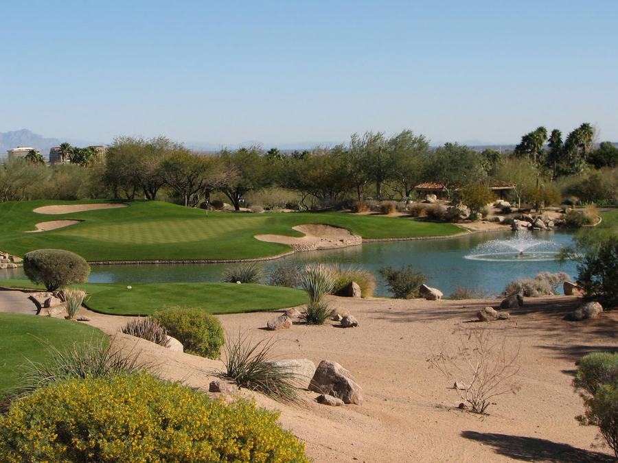 A golf ball resting on a tee against a green fairway